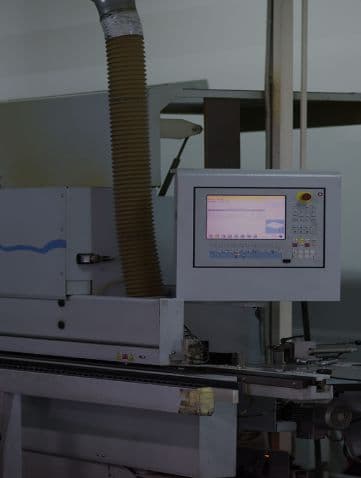 Large industrial manufacturing machine with digital control panel in a workshop